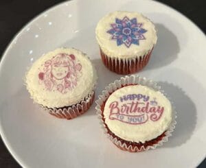 Three frosted cupcakes with decorative edible custom bat or bar mitzvah logos.