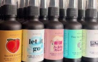 A collection of colorful spray bottles with whimsical labels showing a custom bar or bat mitzvah logo